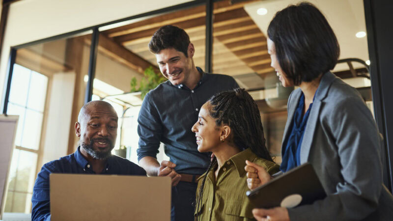 Insurance professionals discussing strategies in a modern office setting.